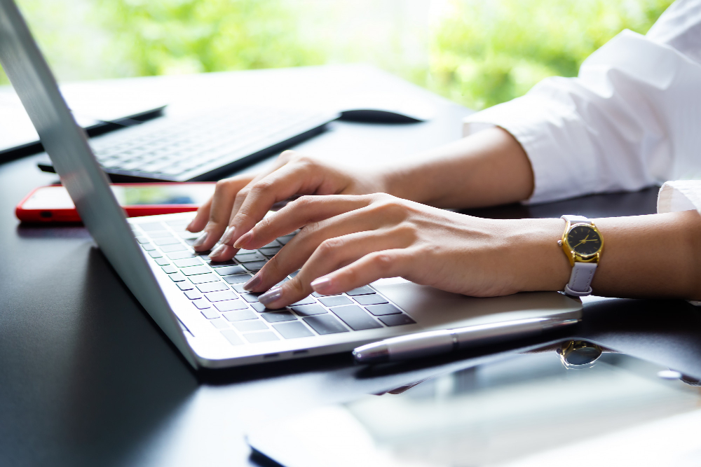 female-hand-typing-keyboard-laptop
